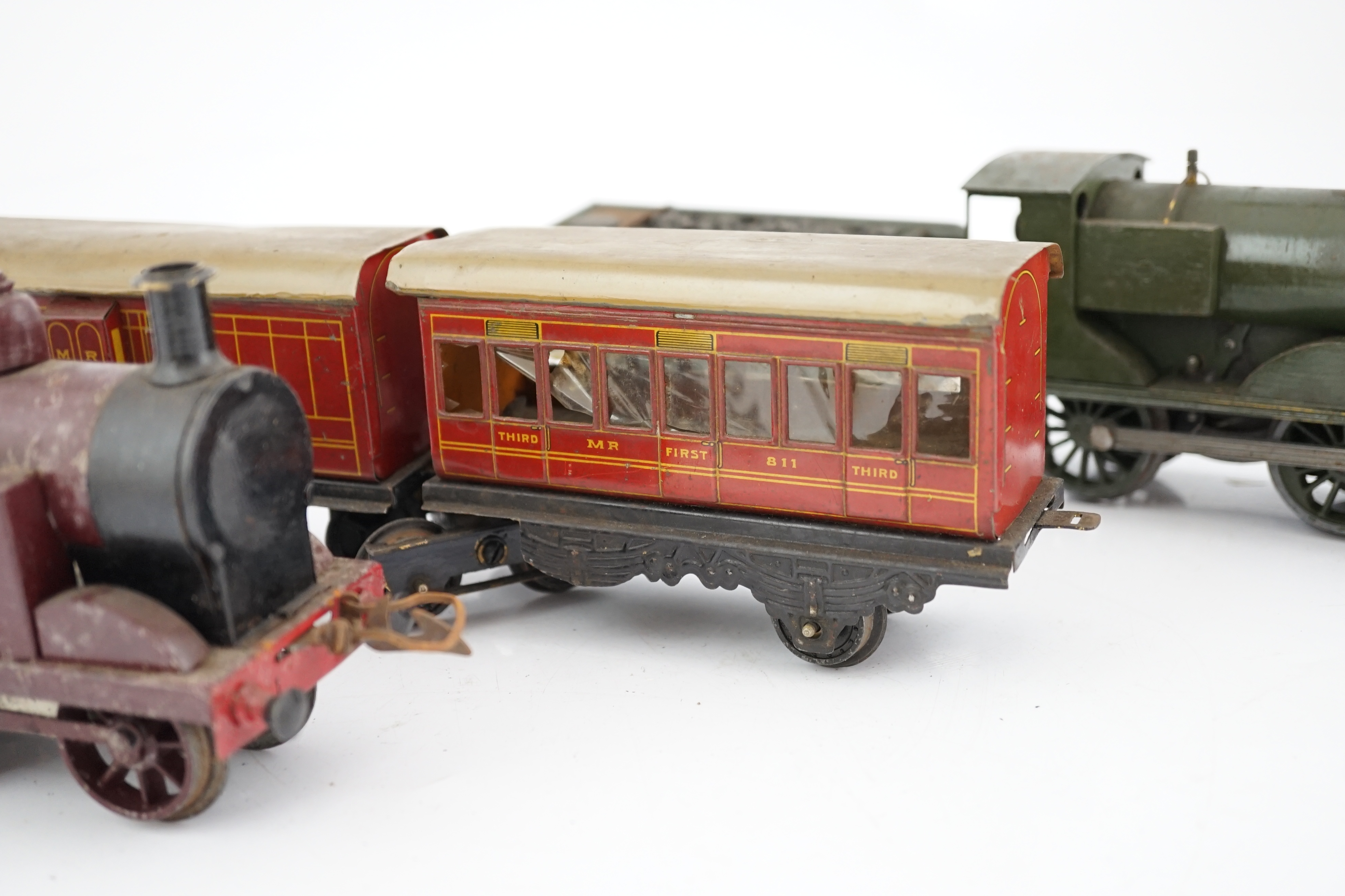 Ten 0 gauge tinplate railway items, most adapted from other parts and models, including three clockwork locomotives; n LSWR 4-4-0 tender loco, an LMS 0-4-4T loco and an SR 0-4-2T loco, together with four SR 4-wheel coach